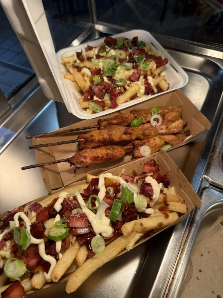 Crispy golden fries stacked high and drizzled with bbq sauce, served with grilled satay chicken sticks.