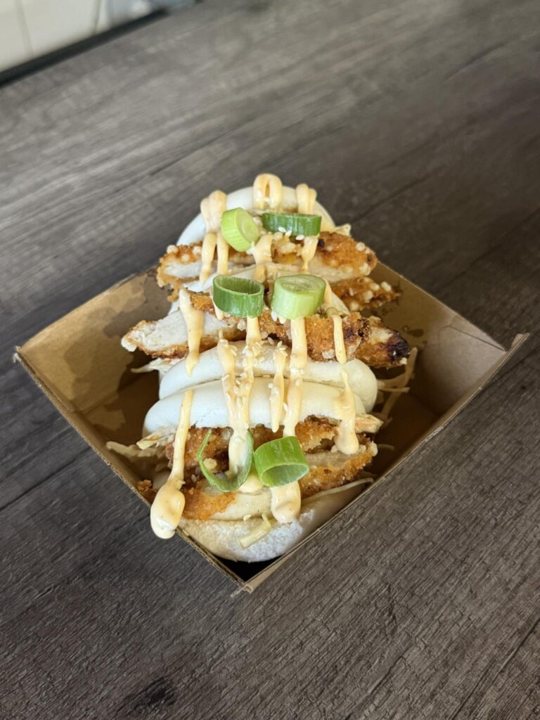 Fluffy bao bun filled with crispy chicken, crunchy coleslaw, and a drizzle of sriracha mayo for a spicy kick.