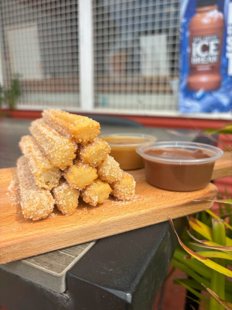 Golden churros dusted with cinnamon sugar, served with Nutella and caramel dipping sauces.